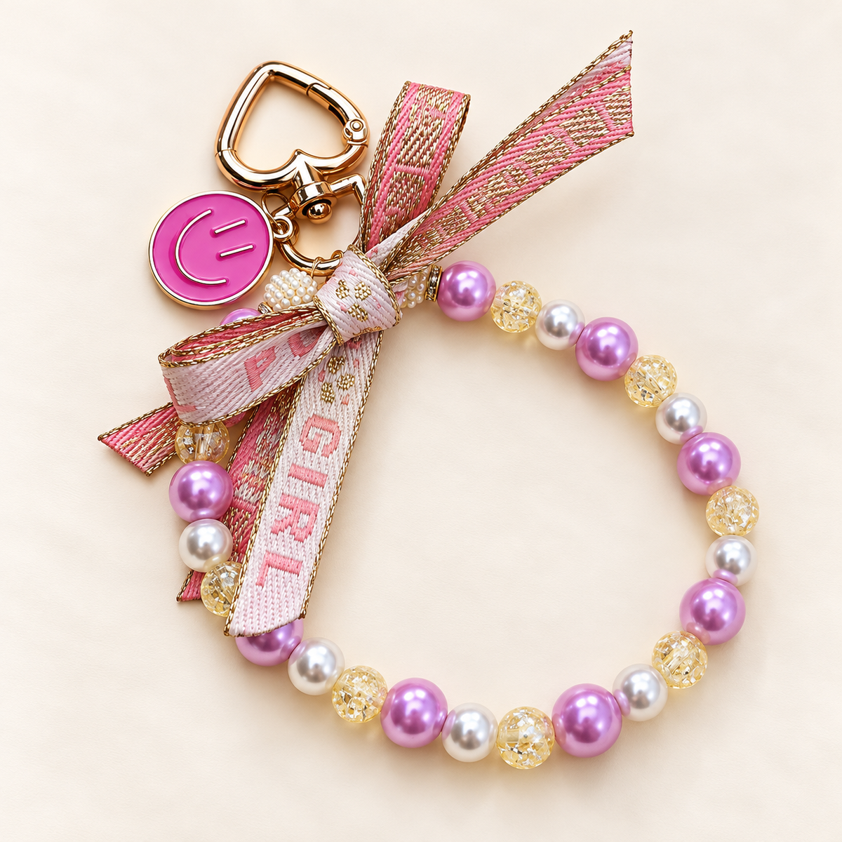 Roze kralenarmband met strik en bedeltjes | Enjoia