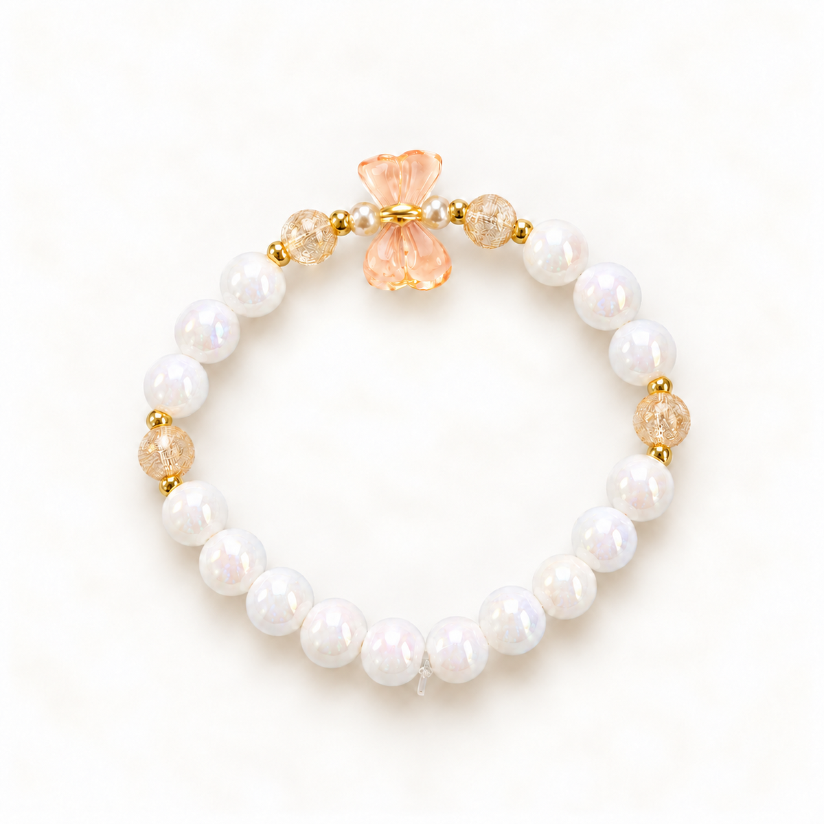 Mini Magic Peach Bow kinderarmband met perzikkleurige strik en witte glanskralen
